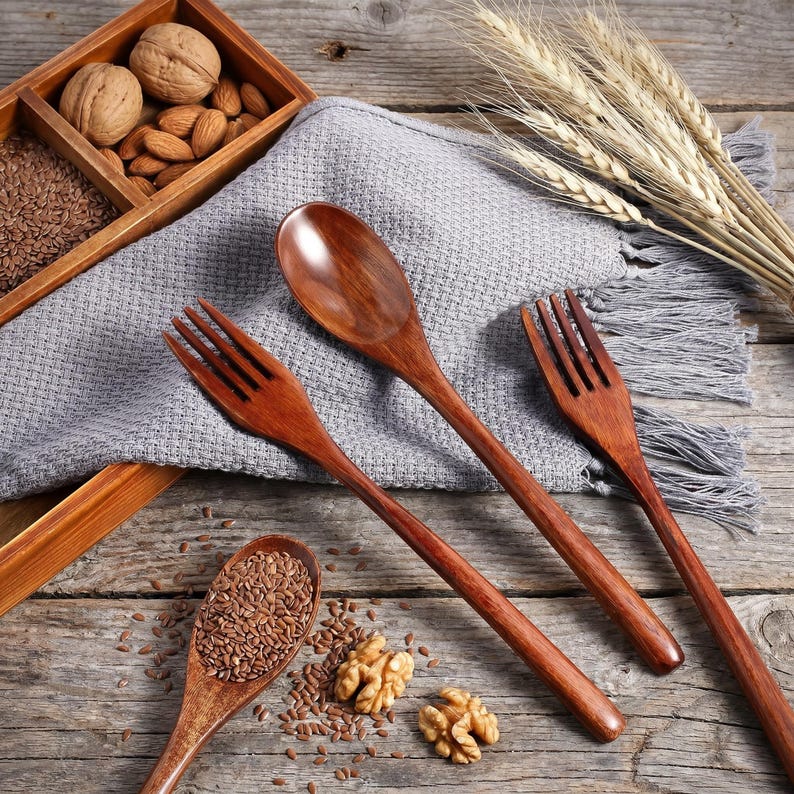 Japanese style wooden spoon and fork set displayed beside a phone for size comparison with measurements shown.