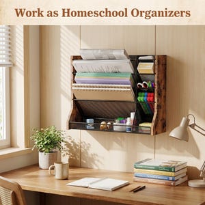 May include: A wooden wall-mounted organiser with multiple compartments, holding papers, notebooks, and stationery. The organiser is brown with a black mesh front. The text "Work as Homeschool Organizers" is at the top. A desk with a plant, mug, and books is in the foreground.