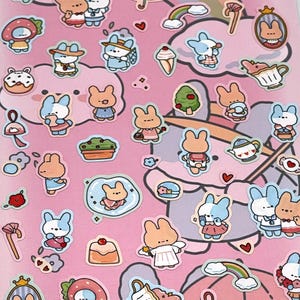 May include: A sheet of stickers with a pink background featuring various cartoon bunnies in different outfits and poses. Other stickers include clouds, rainbows, desserts, and hearts. The stickers are colorful and have a cute, whimsical design.