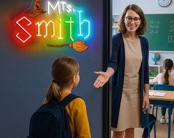 May include: A neon sign with the name "Mrs. Smith" in white and blue, with a witch hat and broom. The sign has a rainbow outline. A teacher welcomes a student in a classroom setting.