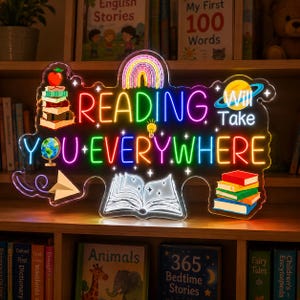 May include: A multi-colored LED neon sign featuring the text READING WILL TAKE YOU EVERYWHERE. The design includes a stack of books with an apple, a globe, a paper airplane, a rainbow, a lightbulb, and an open book with glowing white lines.