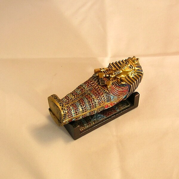 Egyptian Coffin and Figure in Mirrored Cradle Stand
