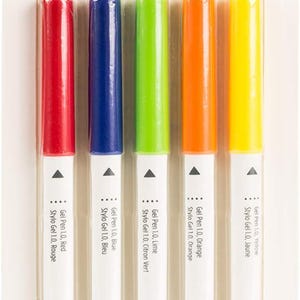 May include: A set of five Cricut gel pens in red, blue, green, orange, and yellow. The pens are labelled with their colours and the Cricut brand name. The pens are designed for use with Cricut Maker and Explore machines.