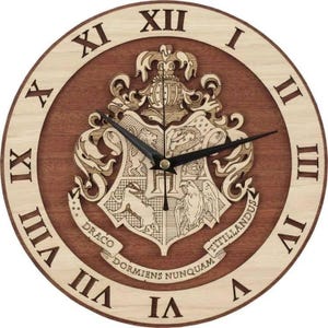 May include: Round wooden clock with a dark brown center and a light brown outer ring. The clock features Roman numerals and black clock hands. The center displays a detailed crest with the words "Draco Dormiens Nunquam Titillandus".