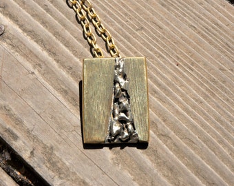 Flowed nickel and brass pendant