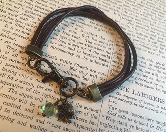 Unisex Brown Triple Strand Leather Bracelet with Four Leaf Clover Charm and Faceted Peridot Bead