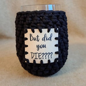 May include: Black crocheted wine glass cozy with a white tag that says "But did you DIE?????"