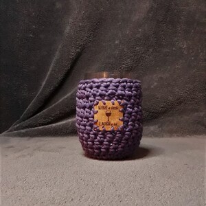 May include: Purple crocheted wine glass holder with a cork coaster that says "Wine a little, Laugh a lot".