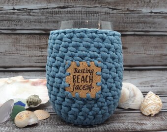 Crochet Stemless Wine Glass Cozy in blue with a Resting Beach Face cork Patch