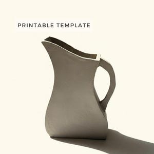 May include: A gray ceramic pitcher with a curved body and a handle. The pitcher has a wide opening and a slightly textured surface. The words "PRINTABLE TEMPLATE" are printed at the top of the image.