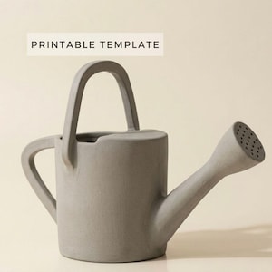 May include: A gray concrete watering can with a curved handle and a spout with multiple holes. The text "PRINTABLE TEMPLATE" is displayed in a white rectangle above the watering can.