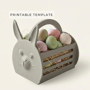 May include: A grey bunny-shaped basket filled with colourful Easter eggs. The basket has a handle and a slatted design. The eggs are pastel colours with gold and white accents. Text on the image reads "PRINTABLE TEMPLATE".