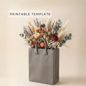 Puede incluir: Un jarrón de cerámica gris con forma de bolsa de la compra, lleno de un vibrante arreglo de flores secas. Las flores incluyen flores naranjas, rojas y blancas, con acentos de lavanda y eucalipto. El texto "PRINTABLE TEMPLATE" se muestra en un rectángulo blanco.