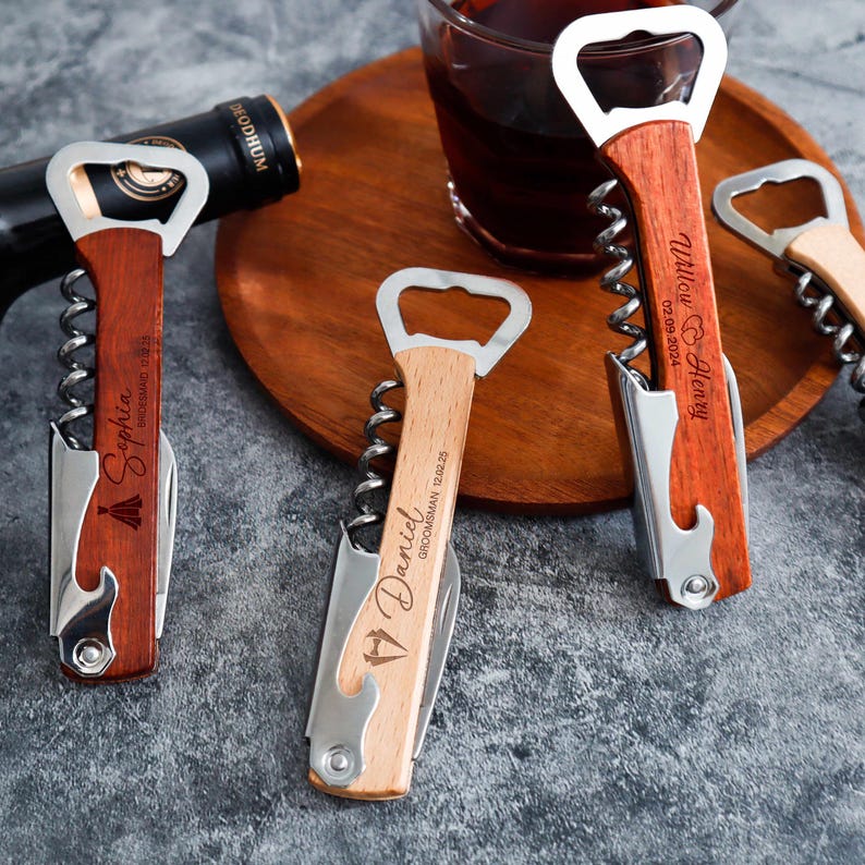 May include: Three multi-functional wine openers with wooden handles and stainless steel mechanisms. Each opener features a unique laser-engraved name, date, and icon. The handles display the names Sophia, Daniel, and Willow & Henry with dates.