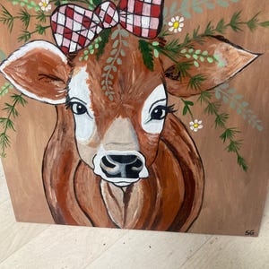 hand-painted cow painting on wood