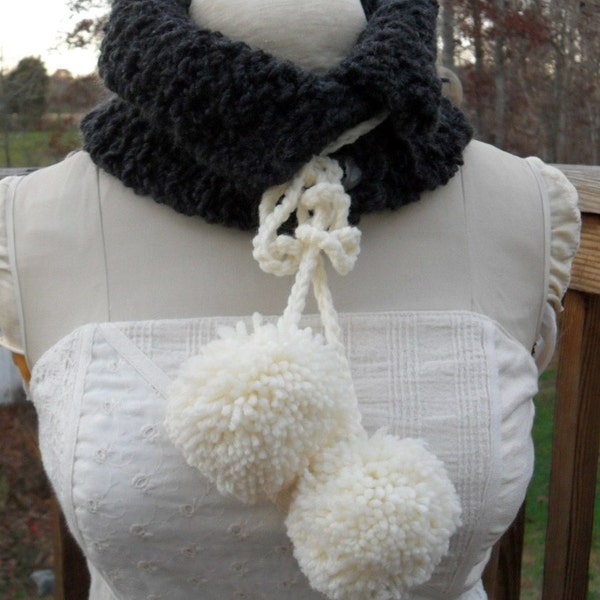 Dark gray curly yarn neckwarmer with big white pom poms