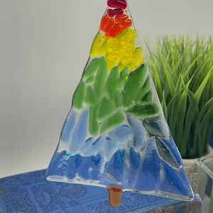 Add a touch of elegance and charm to your holiday decor with our handcrafted fused glass Christmas trees. Each ornament showcases vibrant colors and unique designs that will make your tree truly stand out.