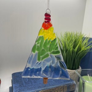 Add a touch of elegance and charm to your holiday decor with our handcrafted fused glass Christmas trees. Each ornament showcases vibrant colors and unique designs that will make your tree truly stand out.