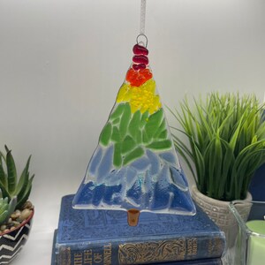 Add a touch of elegance and charm to your holiday decor with our handcrafted fused glass Christmas trees. Each ornament showcases vibrant colors and unique designs that will make your tree truly stand out.