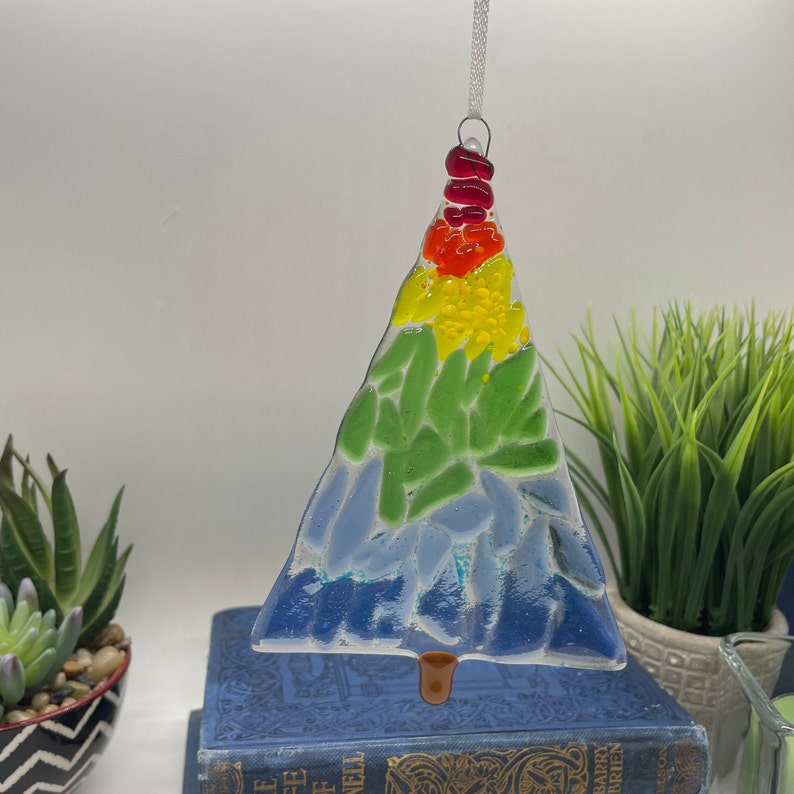 Add a touch of elegance and charm to your holiday decor with our handcrafted fused glass Christmas trees. Each ornament showcases vibrant colors and unique designs that will make your tree truly stand out.