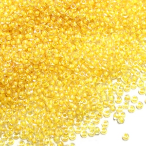 25g Preciosa 10/0 Crystal Color Lined Yellow Rainbow Czech Seed Beads (58583)