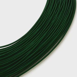 May include: A coiled length of dark forest green elastic cord. The cord features a smooth, rounded profile and is arranged in a series of concentric, overlapping loops that create a dense, uniform texture across the entire visible surface area.