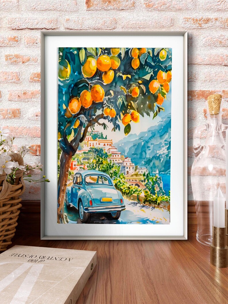 May include: Watercolor painting of a coastal scene with a blue car parked on a road. The artwork features a tree laden with oranges, a village, and a body of water. The painting is framed in a white border.