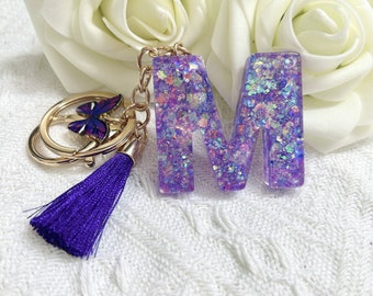 Sparkling sequin Punon resin keychain with 26 letters A to Z, purple butterfly tassel pendant, women's bag accessories, personalized gift