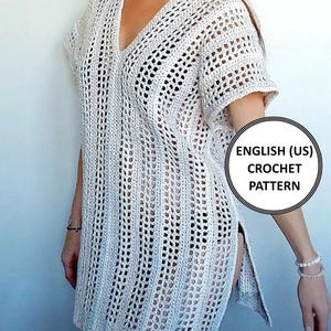 May include: A white, open-weave crochet tunic with a V-neck and short sleeves. The tunic has a split on the side and is knee-length. The image includes the text "ENGLISH (US) CROCHET PATTERN".