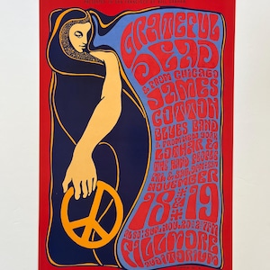 May include: A vintage concert poster for the Grateful Dead and James Cotton Blues Band. The poster features a psychedelic design with a woman holding a peace sign. The concert was held at the Fillmore Auditorium in San Francisco on November 18 and 19, 1969.