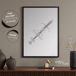 May include: A black and white line art print of a sword with a geometric design. The print is framed in a black frame and is hanging on a light brown wall. The print is titled "abalone studio".