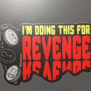 May include: A black and red sticker with the text "I'm doing this for revenge" and a small image of a coin with the year 1992 on it.