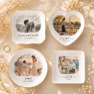May include: Four white ceramic trinket dishes with gold-painted rims, featuring custom printed illustrations of couples and dates. The dishes are square, heart-shaped, and round, displaying names like William and Charlotte, Jennifer and Daniel, D and H, and E and D with dates including 04.12.2026, 06.12.2026, and 28.03.2026.