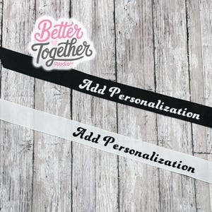 May include: Two strips of grosgrain ribbon, one black with white text and one white with black text, both featuring the phrase Add Personalization in a cursive font. A logo for Better Together Studio is positioned above the ribbons.
