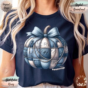 May include: Navy blue t-shirt with a pumpkin design. The pumpkin is decorated with a light blue bow, patchwork patterns, and pearl accents. The words "Original Design" and "Digital Download" are visible.