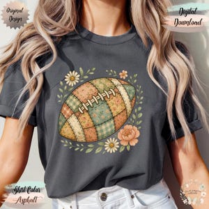 May include: Asphalt-colored t-shirt featuring a patchwork football design with floral accents. The football is composed of various floral patterns in shades of green, orange, and cream. The shirt also has the text "Original Design" and "Digital Download".