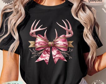 May include: Black t-shirt featuring a pink camouflage bow with gold trim and antlers. The design includes a gold banner and sprigs. The words "Original Design" and "Digital Download" are visible.