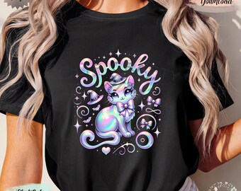 May include: Black t-shirt featuring a holographic cat illustration with a witch hat and bow tie, surrounded by the word "Spooky" in a whimsical font. The design includes bats, stars, and decorative swirls, perfect for Halloween.