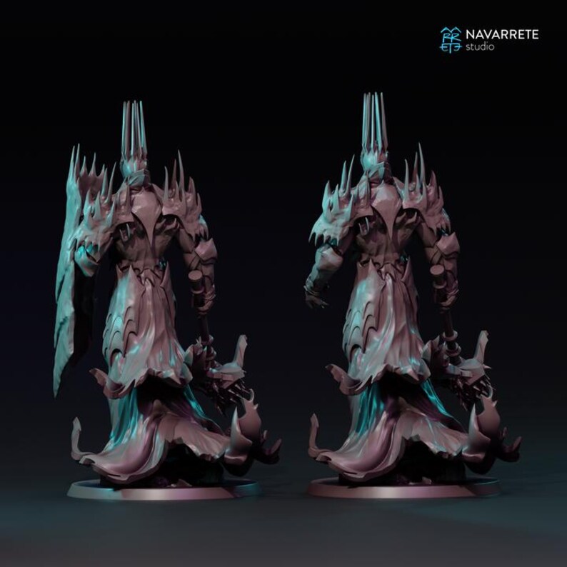 May include: Two detailed, gray fantasy figurines of a regal figure with a tall crown and ornate armor. The figures are posed back-to-back, showcasing intricate design elements. The figures are set against a dark background. The studio logo is in the top right corner.
