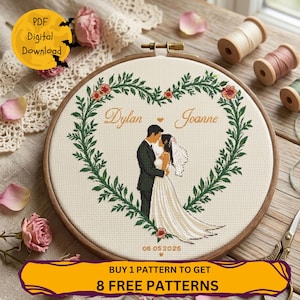May include: A cross-stitch embroidery hoop with a heart-shaped wreath design, featuring a couple's embrace. The names "Dylan" and "Joanne" are stitched in gold, with the date "06 05 2026". Includes a "PDF Digital Download" graphic and a promotional banner.