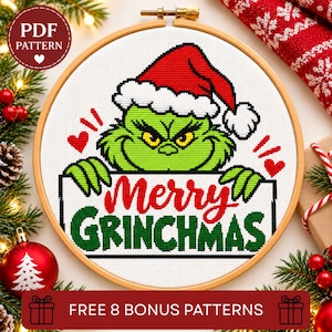 May include: A cross-stitch pattern in a wooden embroidery hoop featuring a green character wearing a red Santa hat. The design includes the red and green text Merry GRINCHMAS, two small red hearts, and a circular badge stating PDF PATTERN.