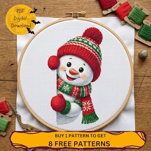 May include: A cross-stitch design of a cheerful snowman in a red and green hat, scarf, and mittens, set within an embroidery hoop. The image includes the text "PDF Digital Download" and "Buy 1 Pattern to Get 8 Free Patterns".