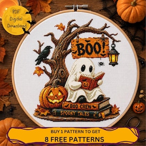 May include: A cross-stitch pattern in a wooden hoop featuring a white ghost reading a book while sitting on two stacked books labeled Boo Crew and Spooky Tales. A jack-o'-lantern, a tree with a black crow, and a hanging lantern are also depicted.