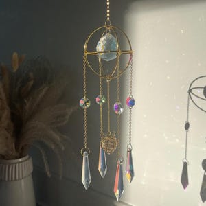Hangende herdenkingsurn, zonnevanger, rouwverwerking, crematie, as, medeleven, herdenkingsgeschenk, urn, regenboogbrug medaillon, doe-het-zelf herdenkingsurn