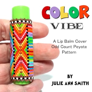 May include: A colorful beaded lip balm cover with a geometric pattern. The cover is made with an odd count peyote stitch. The text "COLOR VIBE" and "A Lip Balm Cover Odd Count Peyote Pattern BY JULIE ANN SMITH" is visible in the image.