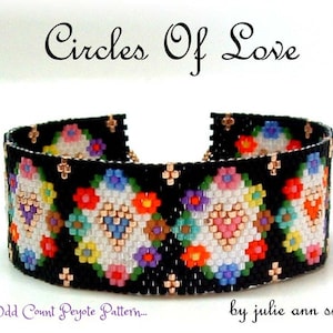 May include: Black beaded bracelet with a floral design. The bracelet features a pattern of colorful flowers in red, pink, blue, and yellow against a black background. The text "Circles Of Love" is at the top.