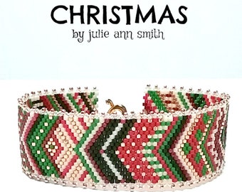 May include: A beaded bracelet with a Christmas-themed design featuring red, green, white, and gold beads. The bracelet is made with a herringbone stitch and has a silver clasp. The text "CHRISTMAS by julie ann smith" is visible above the bracelet.