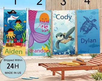 May include: Four personalized beach towels hanging on a clothesline. The towels feature colorful sea creature designs, including a pirate shark, mermaid tail, sea turtle, and jellyfish. Each towel is labeled with a name: Aiden, Brandon, Cody, and Dylan.