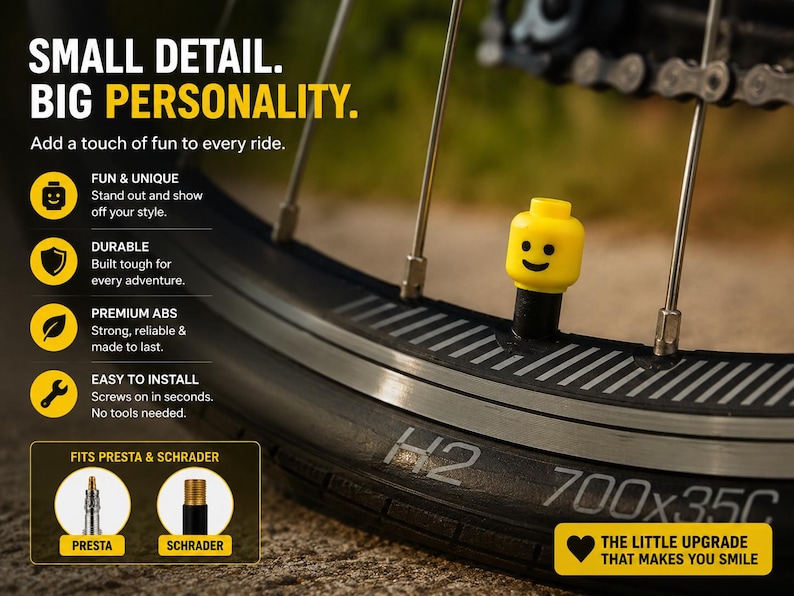 May include: A bright yellow toy-style head valve cap with a black smiling face graphic attached to a bicycle tire valve. The image includes text: SMALL DETAIL. BIG PERSONALITY. Add a touch of fun to every ride. FITS PRESTA & SCHRADER.