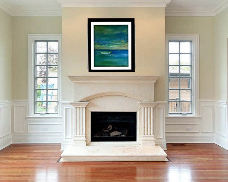 May include: A framed abstract painting with shades of blue, green, and white hangs above a white marble fireplace in a room with hardwood floors and two windows.